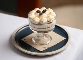 a tirimisu sits on a plate 