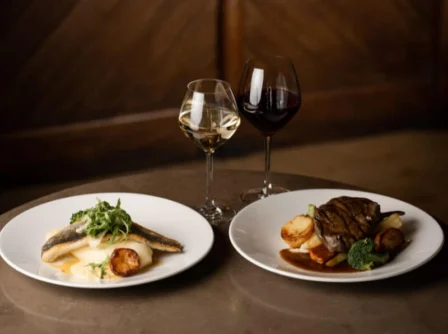 Elegant dining with gourmet dishes and wine at a Hastings Hotel restaurant.