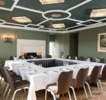 Elegant hotel conference room set for a meeting with a warm, inviting atmosphere.