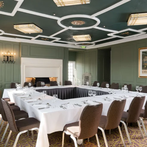 Elegant hotel conference room set for a meeting with a warm, inviting atmosphere.