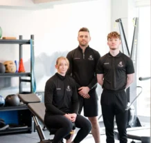 Group of fitness trainers in a modern hotel gym.