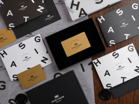 Hastings Hotels gift cards and envelopes on a wooden table.