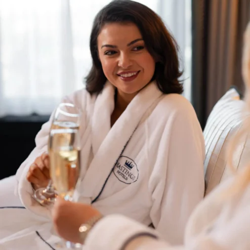 Family enjoying a relaxing moment with champagne in luxurious hotel lounge.