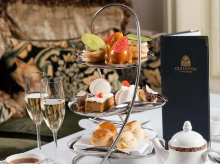 Elegant afternoon tea setup with pastries and champagne at Hastings Hotels.