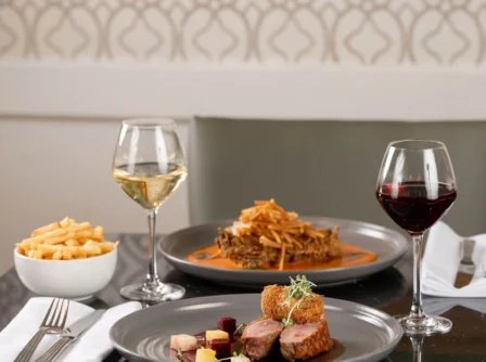 Elegant dining setting with gourmet meals and wine at Hastings Hotel restaurant.