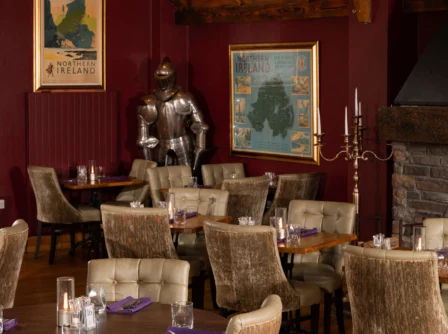 Cosy restaurant with elegant seating and medieval decor in Hastings Hotels.
