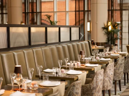 Elegant dining area in a hotel restaurant with tables set for guests.