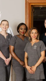 Spa staff standing together in elegant uniforms at The Spa, Culloden Estate and Spa.