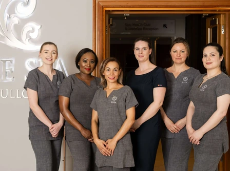 Friendly hotel staff at The Spa at Culloden, welcoming guests in a warm, elegant setting.