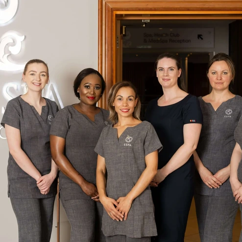 Friendly hotel staff at The Spa at Culloden, welcoming guests in a warm, elegant setting.