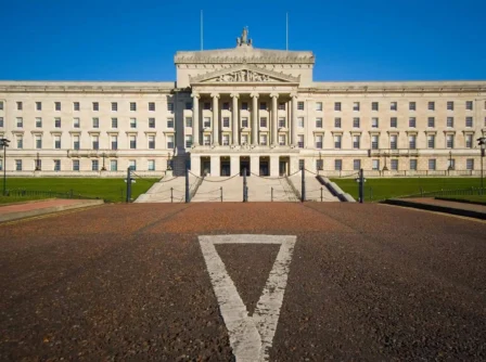 Stunning view of a grand building with a wide pathway, set against a clear blue sky.
