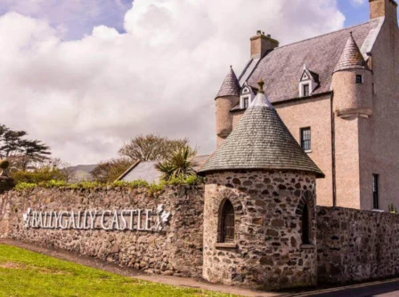 Historic Ballygally Castle exterior under cloudy sky.