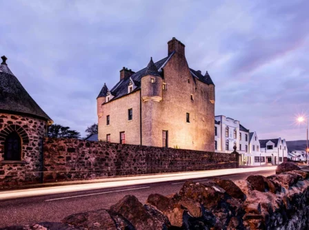 Historic hotel in serene dusk setting with warm lighting and stone architecture.