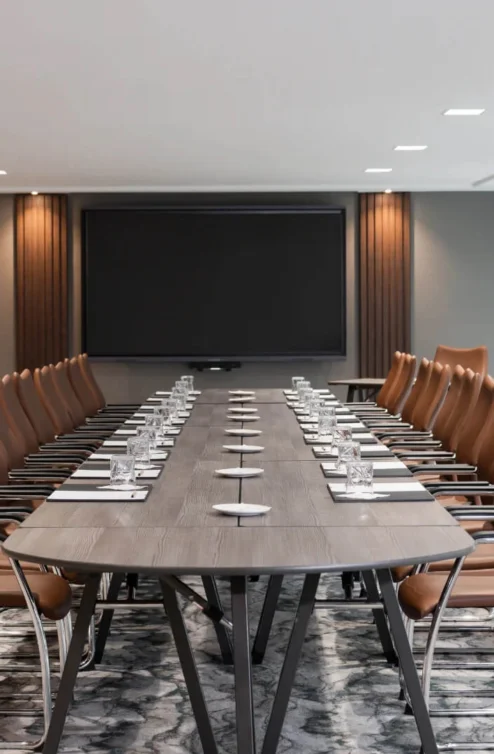 Spacious, modern conference room with elegant furnishings at Hastings Hotels.