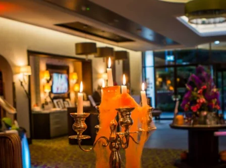 Warm hotel lobby with festive candles and welcoming atmosphere at Hastings Hotels.
