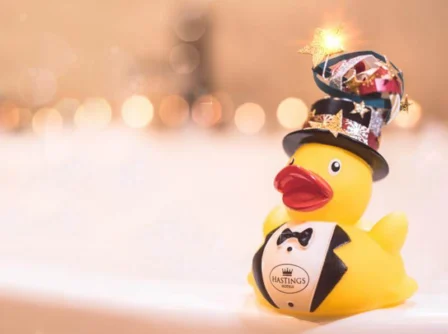 Festive rubber duck with a top hat in a cosy, inviting hotel room at Hastings Hotels.