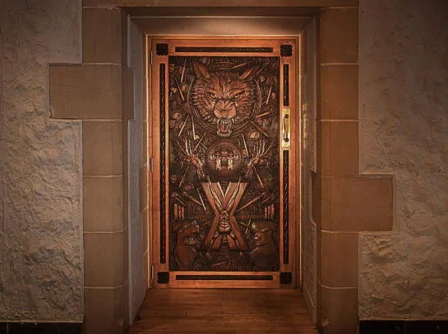 Elegant wooden door with intricate carvings at a Hastings Hotel.