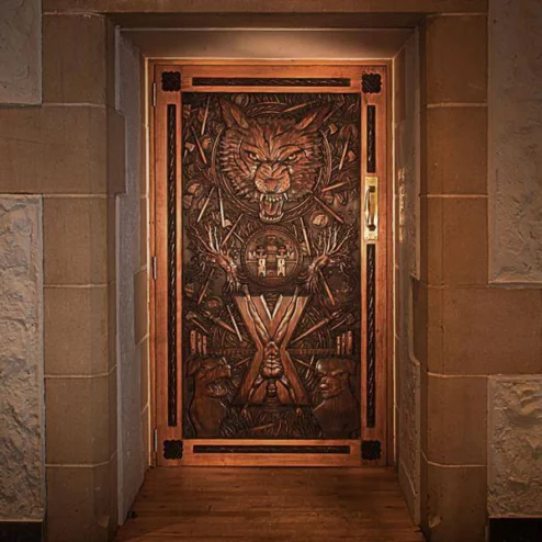 Elegant wooden door with intricate carvings at a Hastings Hotel.