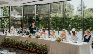 A family enjoying a wedding meal at a beautifully decorated Hastings Hotels venue.